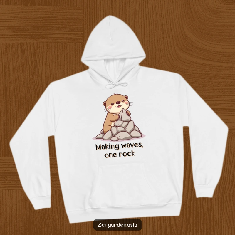 Funny Otter Builder Hoodie: A playful otter smiles contentedly while stacking rocks for a miniature formation, offering cozy, humorous creativity.