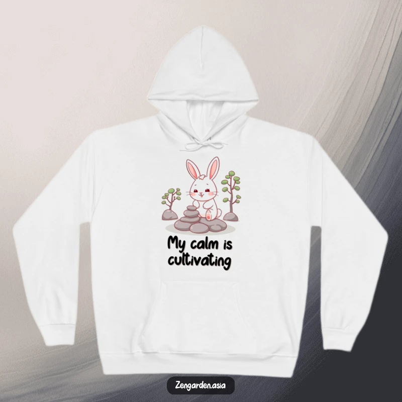Funny Rabbit Zen Hoodie: A cheerful rabbit smiles contentedly while placing stones in a zen garden, offering cozy, humorous relaxation.