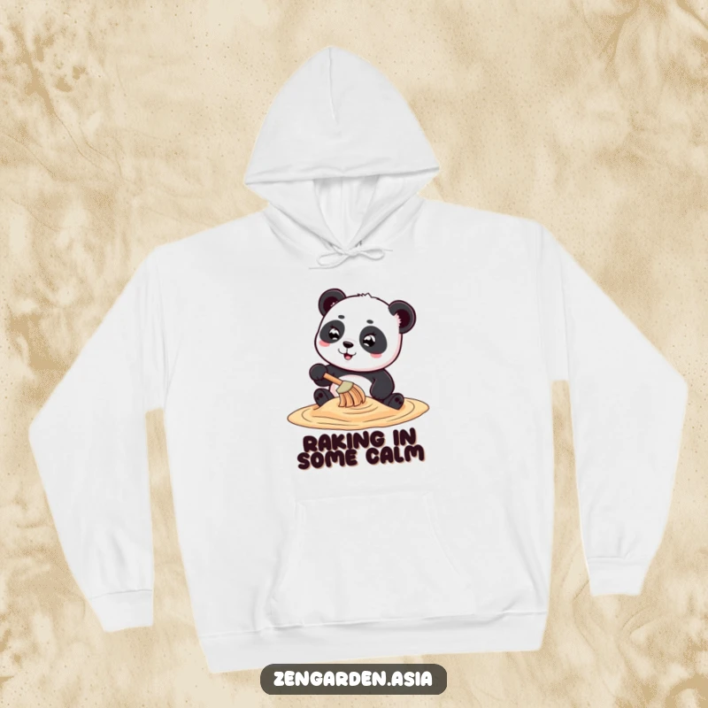 Funny playful panda character creating swirling sand art with a tiny rake, featured on a soft and humorous hoodie.