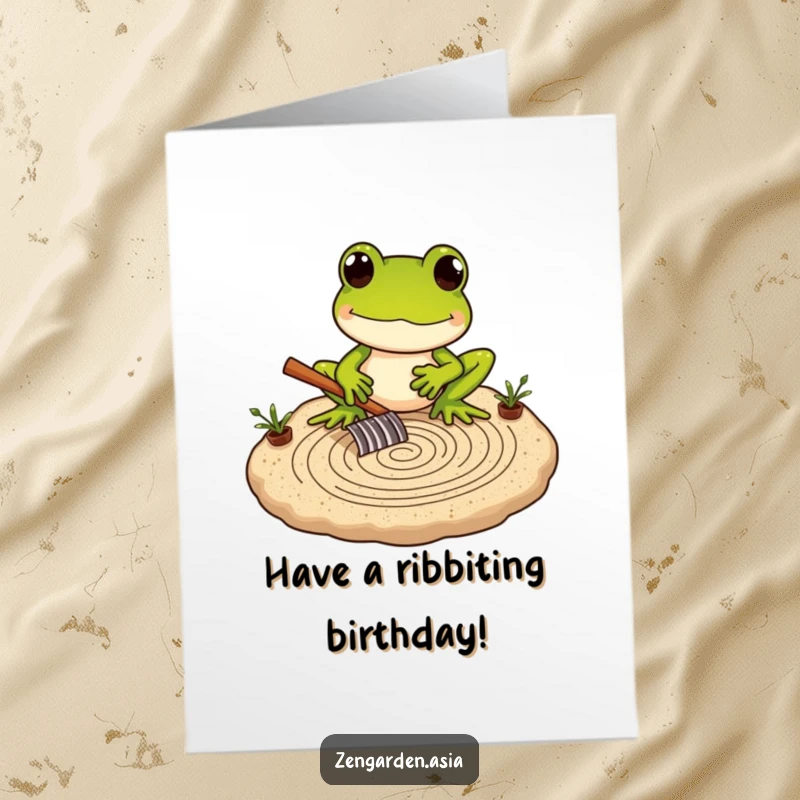 Funny free printable birthday card featuring a frog carefully raking intricate patterns in a miniature sand garden, wishing peace.